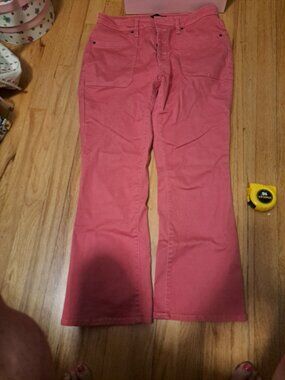 Vibrant pink Daily Thread pants with a button fly and front patch pockets. These